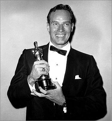 Charlton Heston holding his Oscar