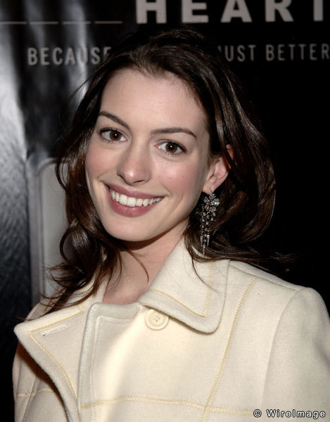 Anne Hathaway in white overcoat