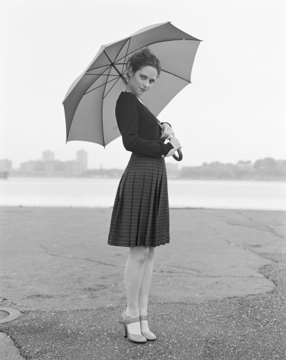 Zooey Deschanel - looks like Audrey Hepburn in black and white pic holding an umbrella