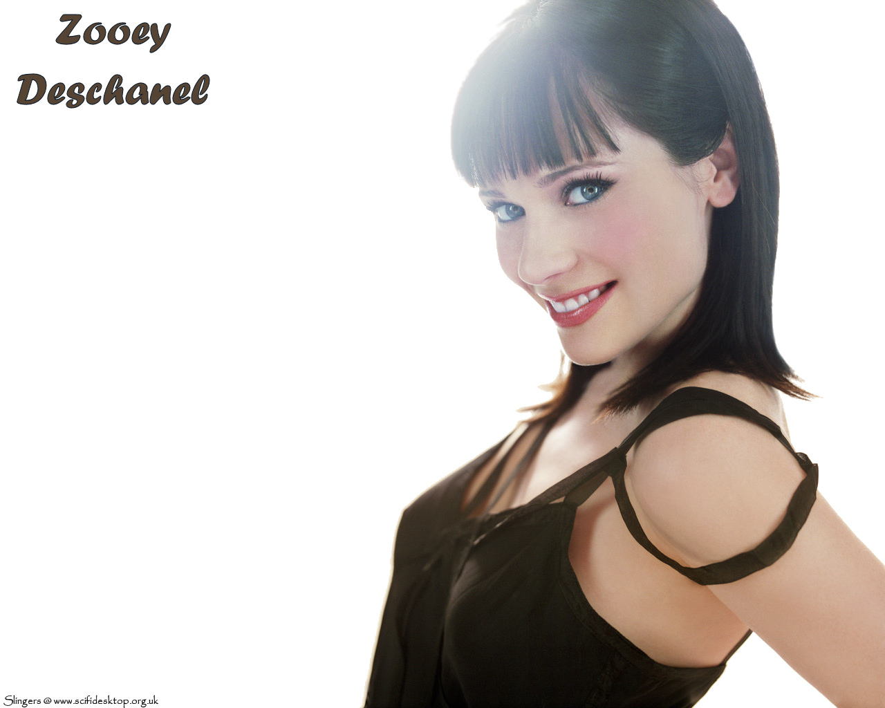 Zooey Deschanel - smiles,  blue eyes shing, shoulders back, chest out. Gotta love a girl who shows off her attributes